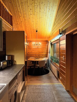 Superior Apartment, River View | Living area | Fireplace, heated floors - Napakettu Holiday Village (Utsjoki)