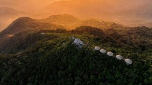 A mountainous landscape with several traditional-style huts. - Minca El Dorado Reserve (Minca)