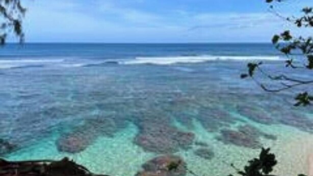 A coastal view with clear water and rocky formations. - Sacred Jungle Hideaway Surf Villa with AC (Princeville)