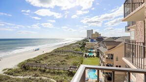 A beachfront hotel with a pool, beach access, and a view of the ocean. - Wake Up to Waves | Stunning Oceanfront Condo (North Myrtle Beach)