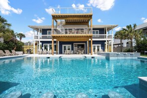 A two-story building with a pool in front. - New Beach Listing! Harmony Key - 8BR, 5Bath, Private Beach, Pool, Spa! (Pensacola)