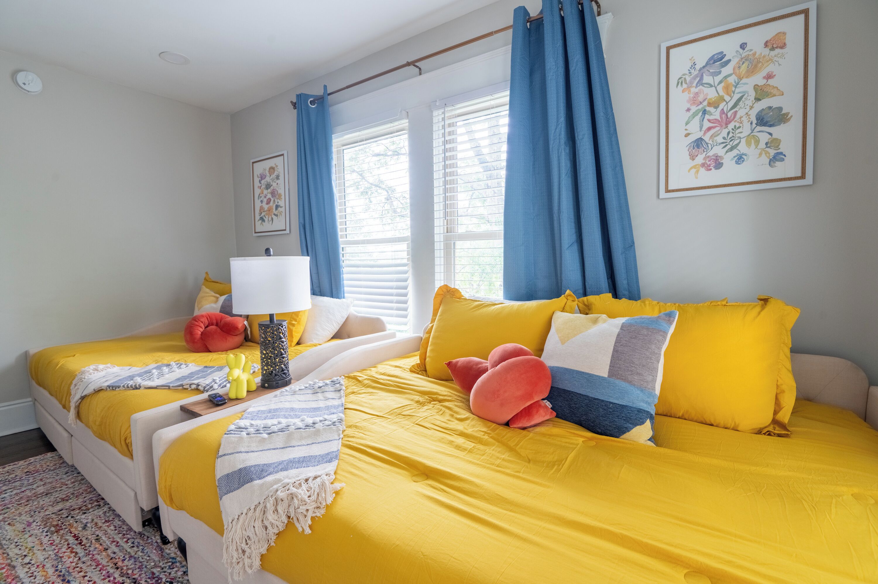 Restful Retreat: Our thoughtfully designed guest bedroom features two full-sized daybeds with convenient under-bed storage and a smart TV. Perfect for additional guests, this space combines pr