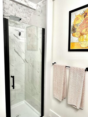 Shower, hair dryer, towels, toilet paper
