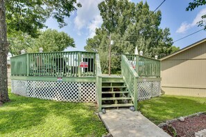 A gated private property with a wooden staircase leading to a covered area. - Pool & Large Covered Patio! Decatur Family Getaway (Decatur)