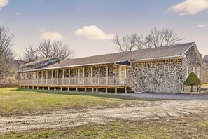 A long, single-story building with a stone facade and a wooden deck. - Studio Retreat | Near Woodbury Commons & Legoland (Monroe)