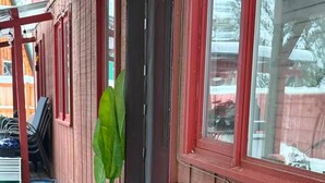 A building with a red exterior, a mailbox, and a potted plant near the entrance. - Close to everything you need Unit B Entire rental unit in Fairbanks, Alaska (Fairbanks)