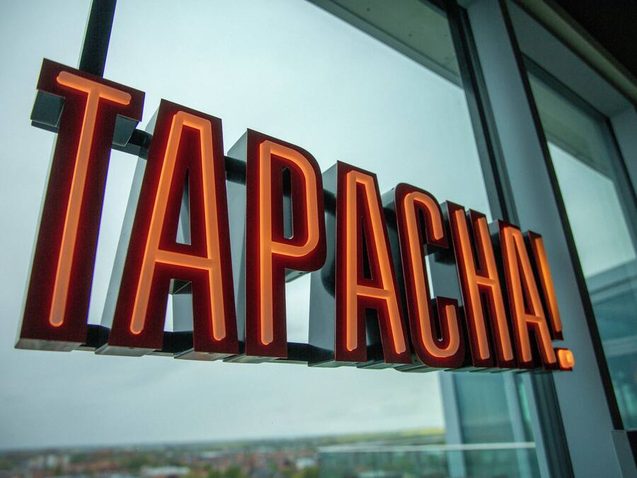 A sign with the word 'TAPACA' in bold, illuminated letters.
