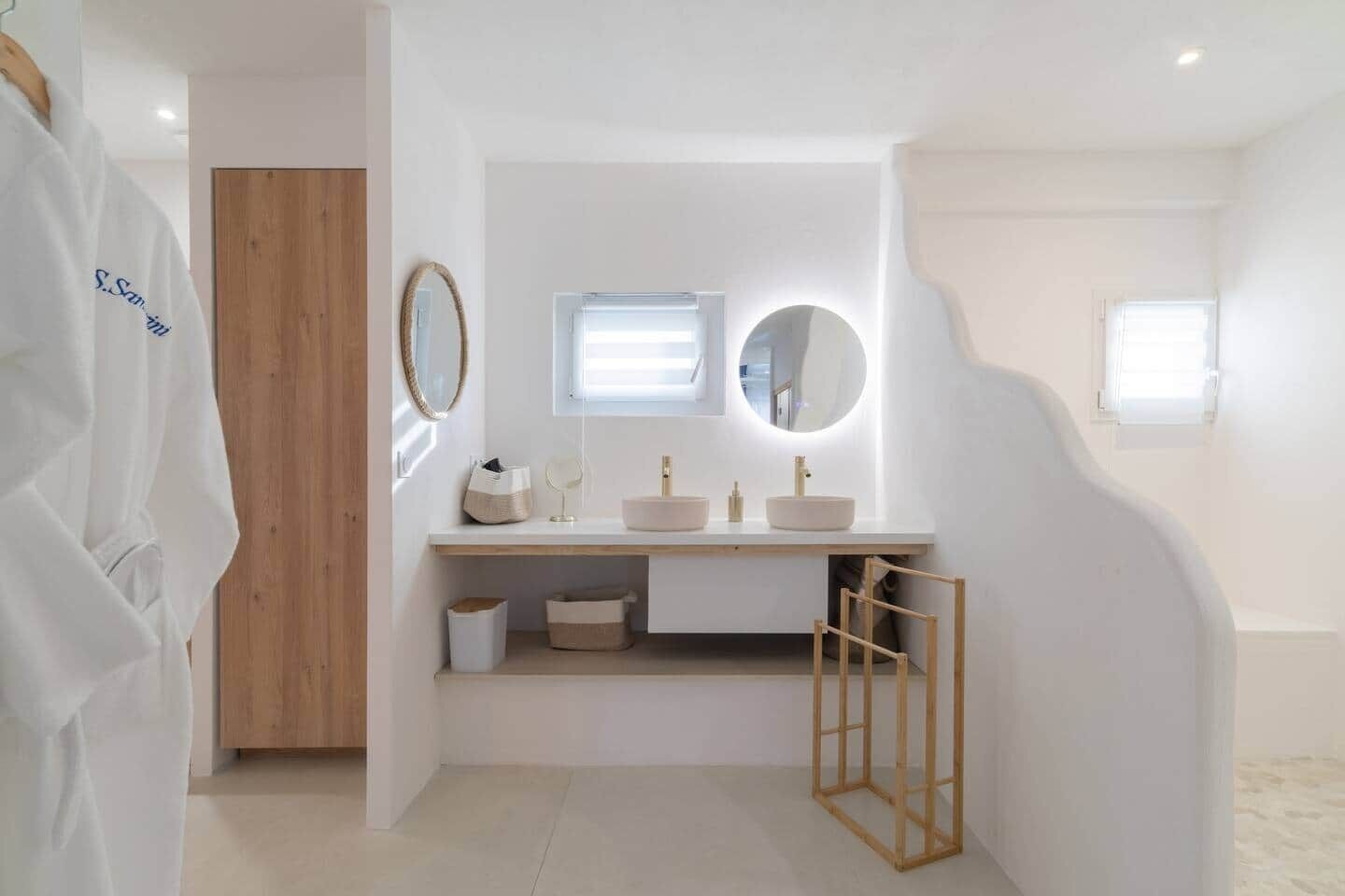 A modern bathroom with a wooden vanity, two sinks, and a mirror.