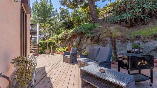 A deck with outdoor furniture, a grill, and a variety of plants. - Casa De La Campanita
1 Bed, 1 Bath (San Marcos)