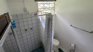 Un baño con ducha, inodoro y lavamanos.