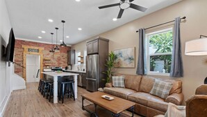 A compact living space with a kitchen, dining area, and seating area. - Historic 1907 SLC Victorian - Hot Tub - Firepits - (South Salt Lake City)