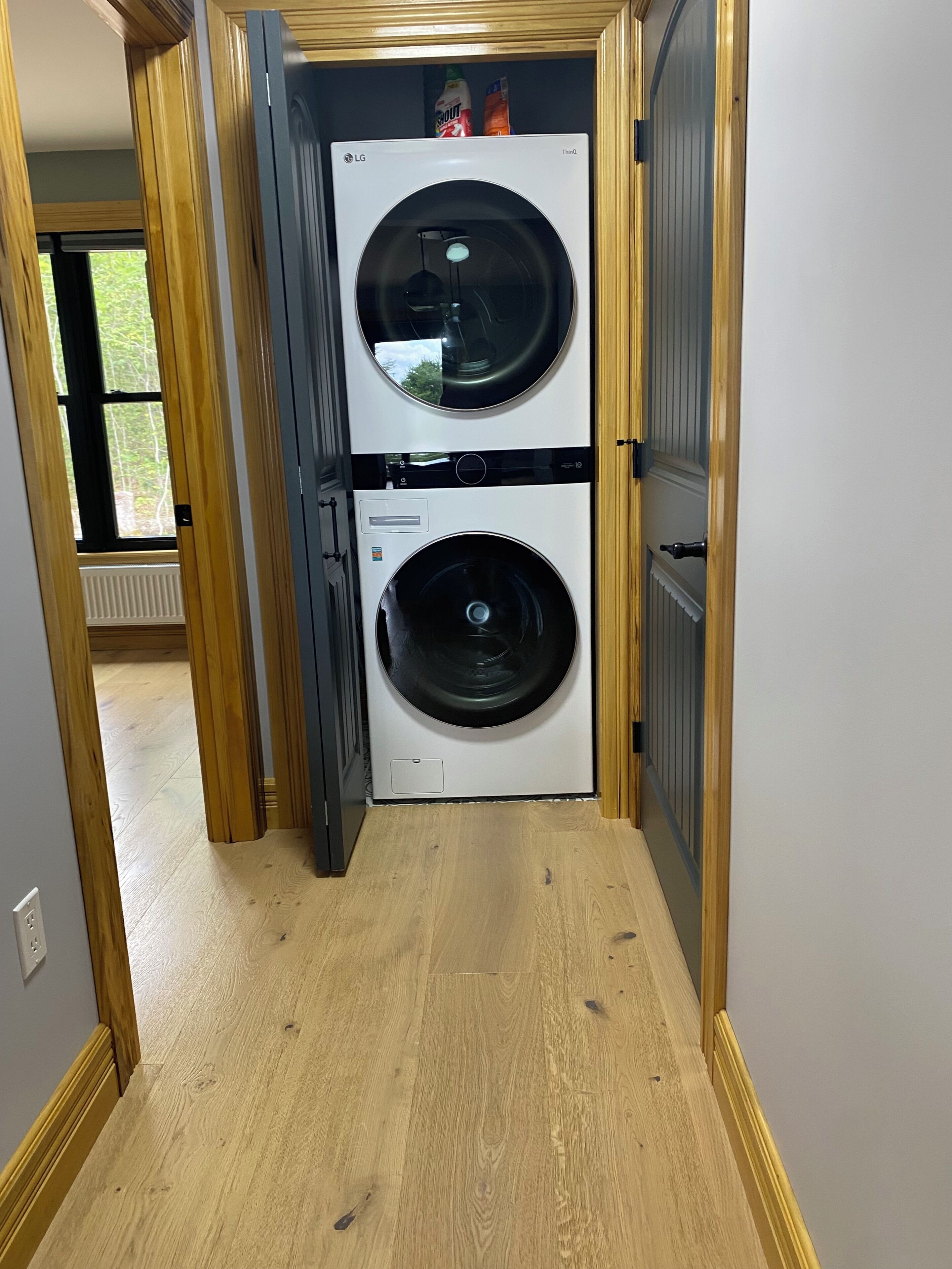 A laundry room with two stacked washing machines.