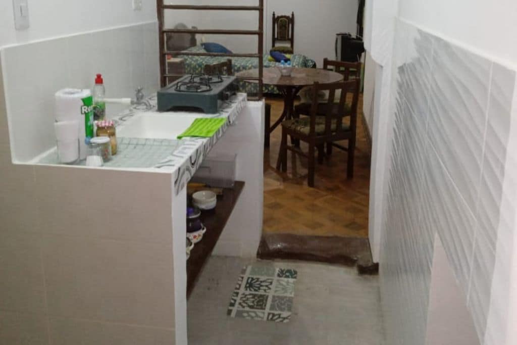 A compact kitchen with a gas stove, sink, and various kitchen items.
