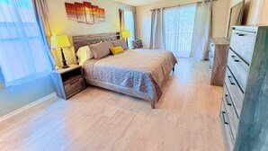 A bedroom with a bed, nightstands, a dresser, and a ceiling fan. - Regal Palms 4BR Getaway • Resort Stay • Great for Families (Davenport)