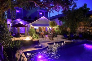 Pool area & Pool House - Settle into a spacious private king suite with an en-suite bath and large private balcony in our historic boutique guesthouse. Enjoy shared living spaces, lush tropical gardens and a heated saltwater pool, just one mile from the French Quarter. (New Orleans)
