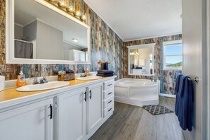 A bathroom with a large mirror, two sinks, a bathtub, and a shower. - A Scenic Custer Getaway with Space, Comfort, & View of the Needles (Custer)