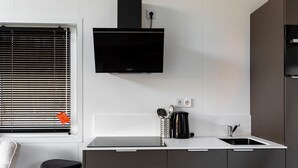A modern kitchen with a built-in stove, a sink, and a black coffee maker. - 2 bedroom stunning home in Wenum-Wiesel (Wenum-Wiesel)