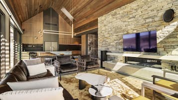 A modern interior with a stone wall, a flat-screen TV, and a cozy seating area.