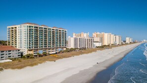 A beachfront hotel with multiple floors, a sandy beach, and ocean waves. - 1502 True North 3 BR 3 BA Ocean View Condo (North Myrtle Beach)