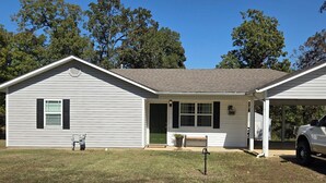 A single-story house with a covered porch, a front door, and a small front yard. - Cozy 2-bedroom house in beautiful Pocahontas with AC (Pocahontas)