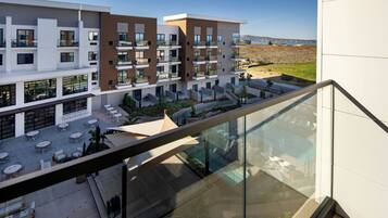 A modern building with multiple balconies and outdoor seating areas.