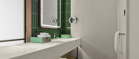 A modern bathroom with a white sink, green-tiled wall, and a mirror with built-in lights.