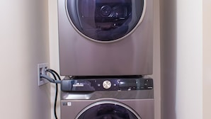 Eine gestapelte Samsung Waschmaschine und Trockner in einer Diele mit fußbodenmuster.
