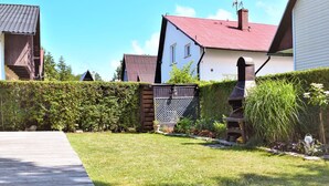 A residential area with a well-maintained lawn, a wooden pathway, and a variety of houses with different architectural styles. - 1 bedroom amazing apartment in Rowy (Rowy)