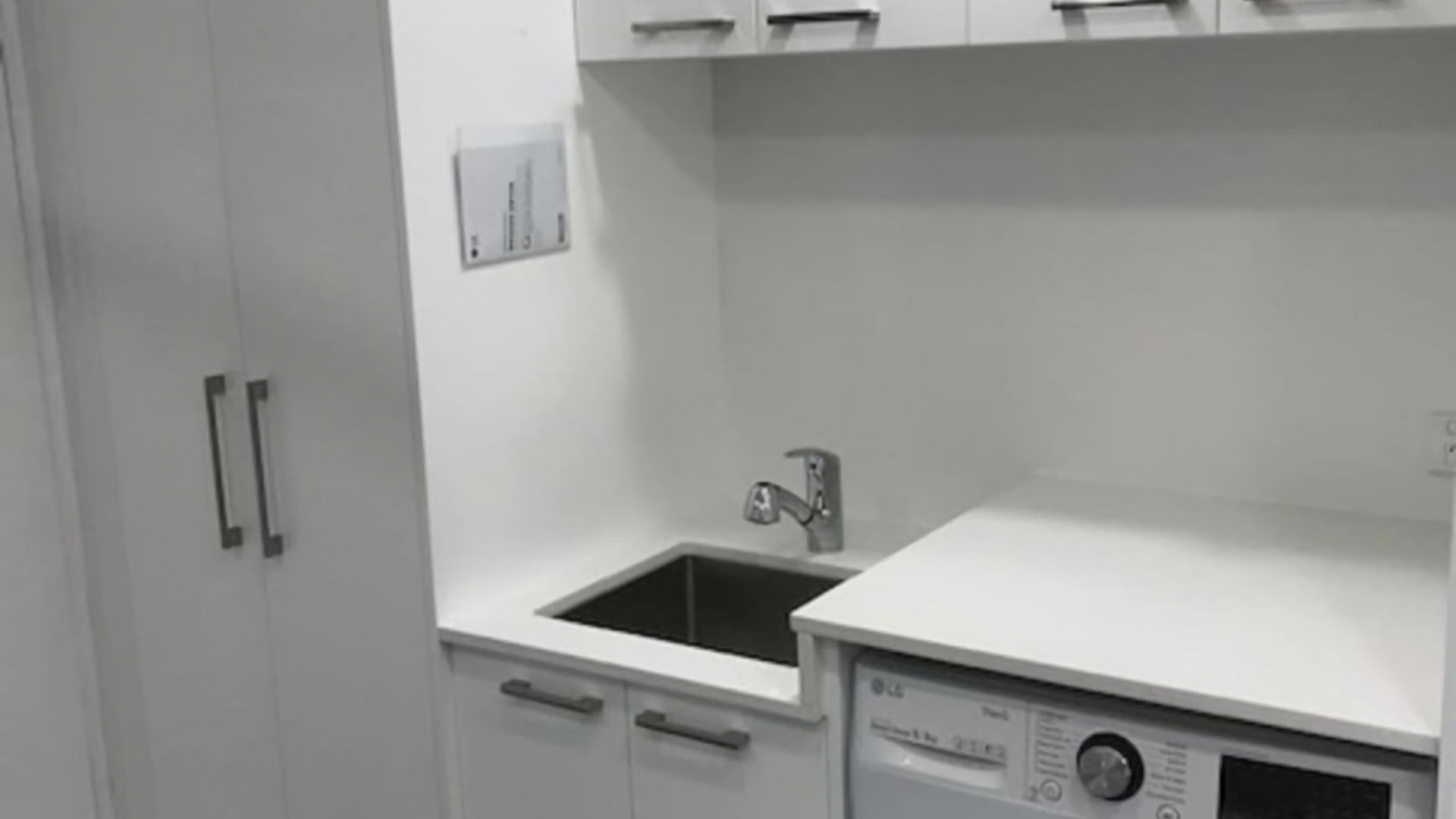 A kitchen with a built-in dishwasher, a sink, and cabinets.