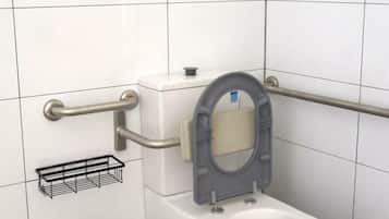 A modern bathroom with a white toilet, grab bars, a bidet, and a trash bin.