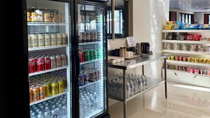 A self-service beverage station with various drinks and a payment system. - Gallery Boutique Hotel (Bibra Lake)