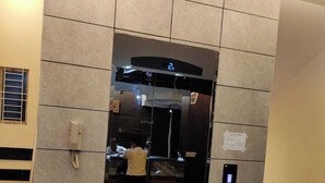 A modern elevator with a digital display showing the number 2, surrounded by beige tiles. - Hotel Riverview Kishorganj (Kishoreganj Sadar)