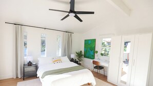 A bedroom with a bed, a desk, a chair, a ceiling fan, and a wardrobe. - Cozy La Costa Studio Retreat (Carlsbad)
