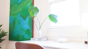 A room with a desk, a chair, a window, and a painting. - Cozy La Costa Studio Retreat (Carlsbad)