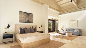 A spacious bedroom with a large bed, a grey sofa, and a wooden ceiling.