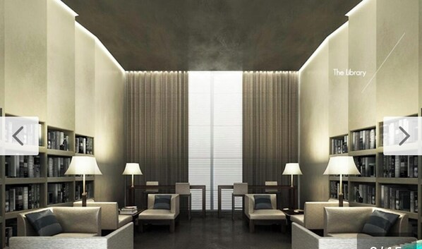A modern library with bookshelves, two sofas, and lamps. - Century Spire Condominium (Makati)