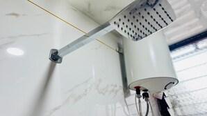 A ceiling-mounted showerhead with a long, adjustable arm, attached to a white marble wall. - SAIRAM RESIDENCY (Khuldabad)