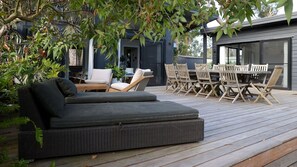 A deck with a sofa, chairs, and a table. - The Getaway is pet friendly (MANYANA)