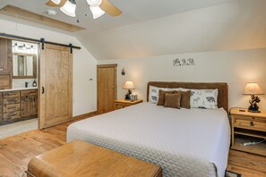 A bedroom with a large bed, wooden floor, a sliding door, a dresser, and a ceiling fan. - Ski, Hike & Relax: Pagosa Springs Gem w/ Sauna! (Pagosa Springs)