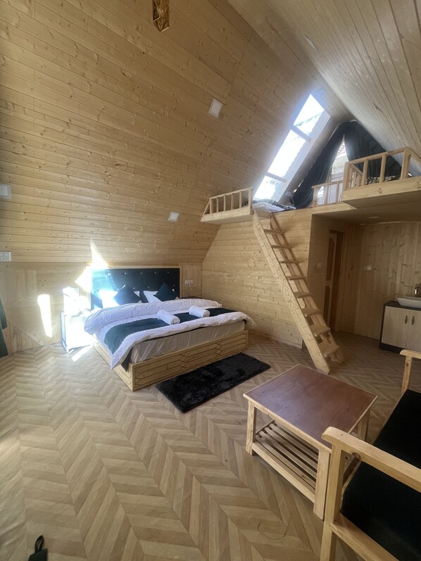 A wooden interior with a bed, a desk, and a staircase. - The Grand Lamkhaga By Mountain Bee (Chitkul)