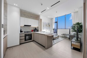 Private kitchen - Chic 1BR Retreat with Pool & Balcony JVC (Madinat Zayed)