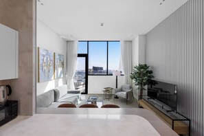 Living area - Chic 1BR Retreat with Pool & Balcony JVC (Dubai)