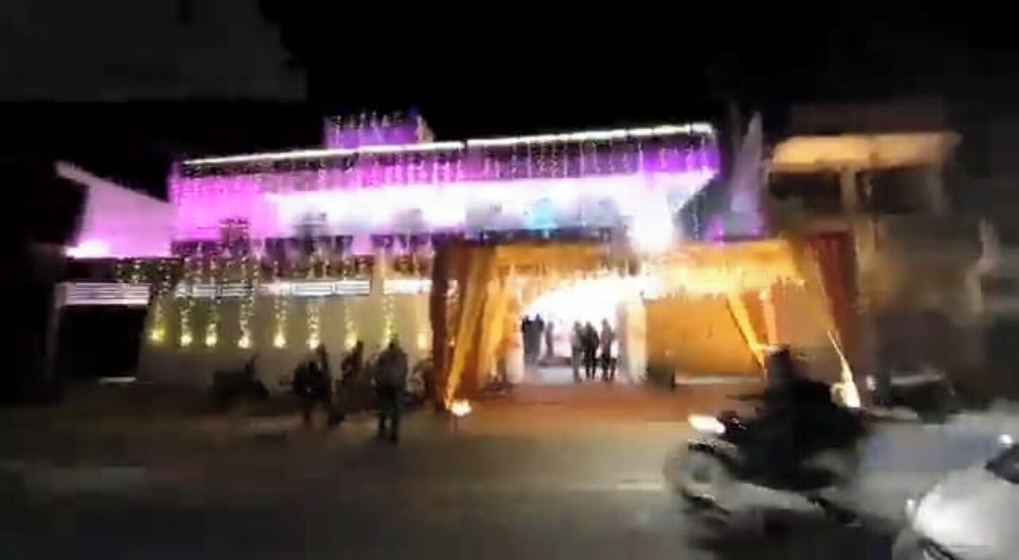 A building with a large entrance and a brightly lit facade.