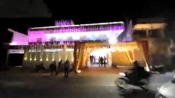 A building with a large entrance and a brightly lit facade.