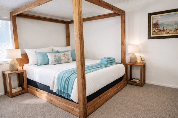 Comfortable master suite with a queen bed and pull-out sofa, providing extra sleeping space.