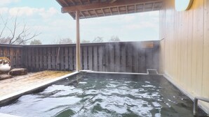 A hot tub area with a wooden deck and a covered section. - Yamano Takohei (Azumino)