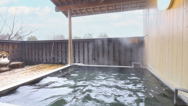 A hot tub area with a wooden deck and a covered section. - Yamano Takohei (Azumino)