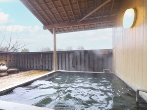 A hot tub area with a wooden deck and a covered section. - Yamano Takohei (Azumino)