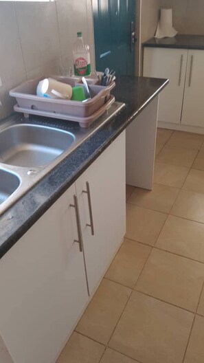 Fridge, cookware/dishes/utensils - Theo's Self  Catering  holiday home, Meanwood (Lusaka)