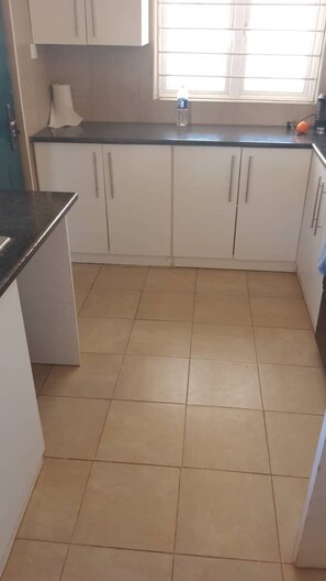 Fridge, cookware/dishes/utensils - Theo's Self  Catering  holiday home, Meanwood (Lusaka)